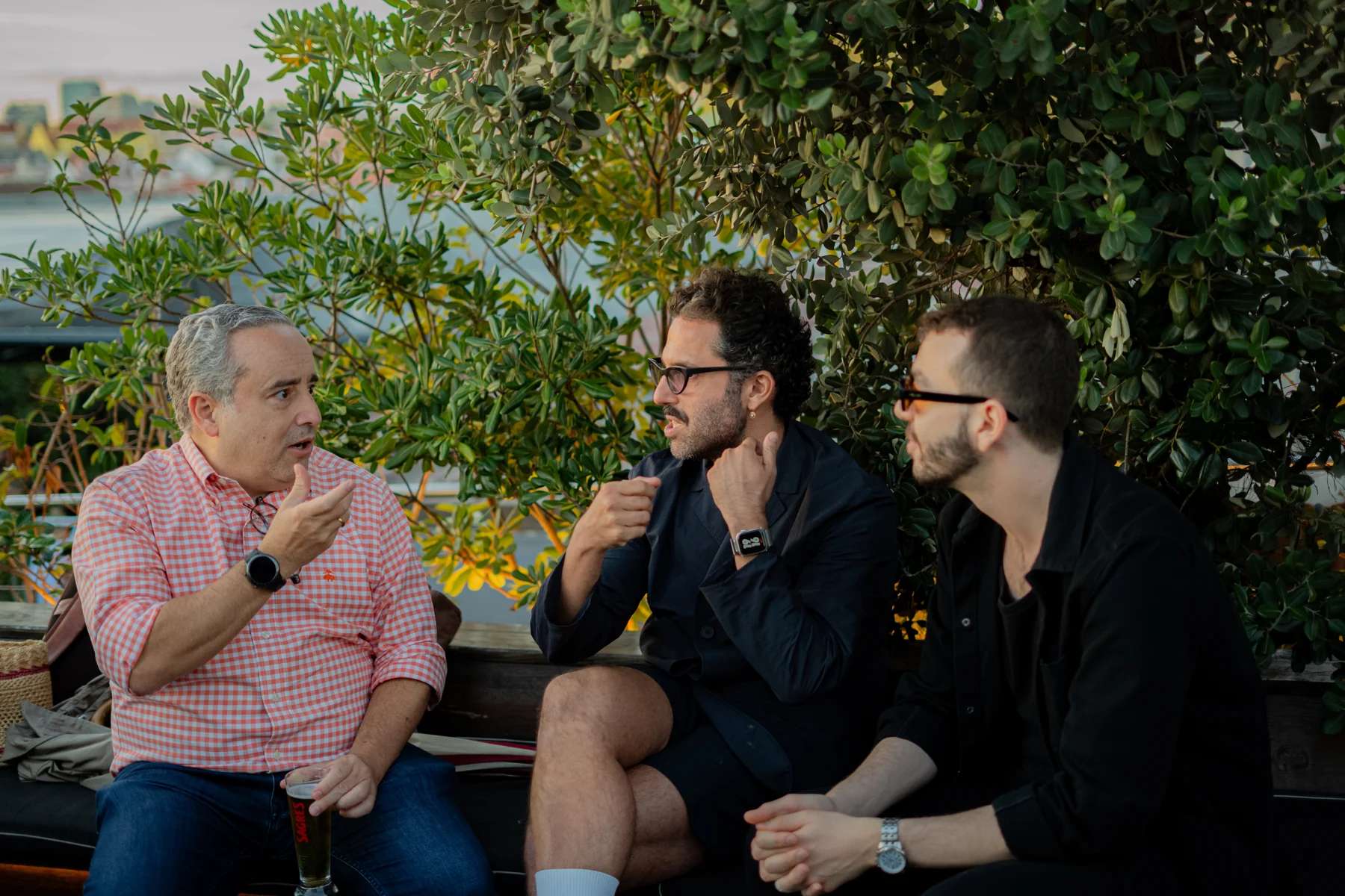 Three Onfound community members in conversation at a rooftop event